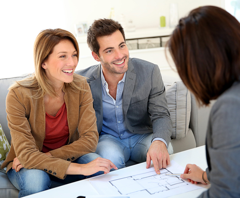 couple overviewing blueprints with a True North representative